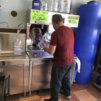 62 Spot - a man in a red shirt filling up a bottle of water - Water Stores Near Me - Yucca Valley, California 62 Spot - a man in a red shirt filling up a bottle of water - Water Stores Near Me - Yucca Valley, California