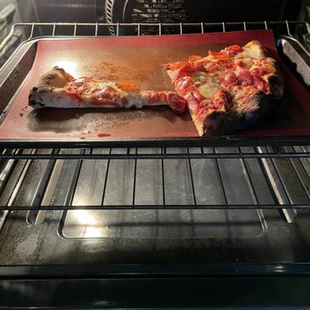 Spuntino Pizzeria - Me putting the pizza immediately in the oven cause, cold! I live 3 minutes from the place! - Italian Near Me - Temecula, California