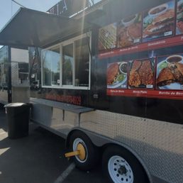 a food truck parked in a parking lot a food truck parked in a parking lot