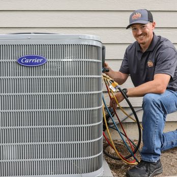 Hooley Heating & Air - AC technician repairing an air conditioner unit in Colorado - Heating & Air Conditioning/HVAC Near Me - Fort Collins, Colorado Hooley Heating & Air - AC technician repairing an air conditioner unit in Colorado - Heating & Air Conditioning/HVAC Near Me - Fort Collins, Colorado