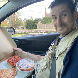 Amano Pizza - Joe enjoying his own rice balls with a slice and a square. Beautiful!