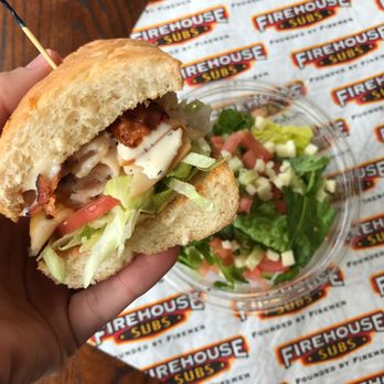 Firehouse Subs - a hand holding a sandwich - Sandwiches Near Me - Lansing, Michigan Firehouse Subs - a hand holding a sandwich - Sandwiches Near Me - Lansing, Michigan