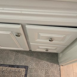 Crooked cabinet in the bathroom. Door and drawers won't close.
