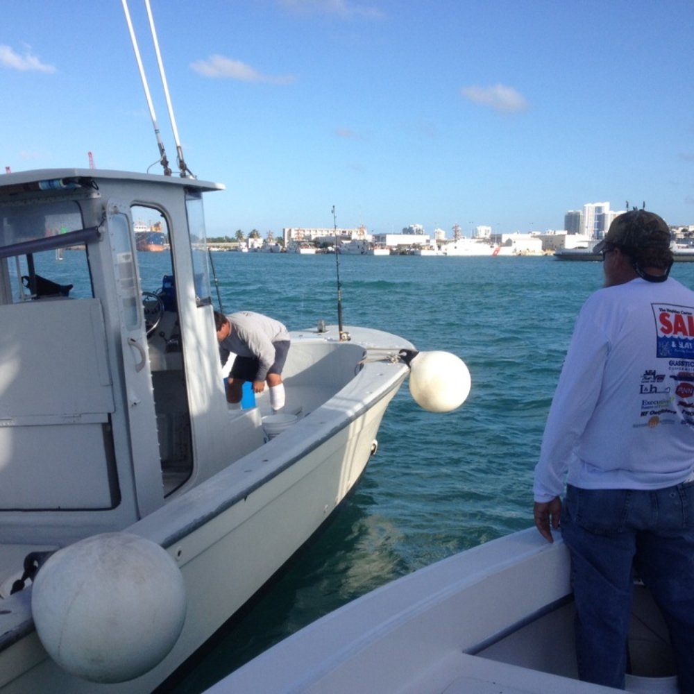 Blue Waters ll - Getting bait from the bait boat - Boat Charters Near Me - Miami, Florida