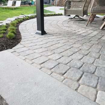 Gorman Landscapes - a patio with a brick paver and chairs - Landscaping Near Me Gorman Landscapes - a patio with a brick paver and chairs - Landscaping Near Me