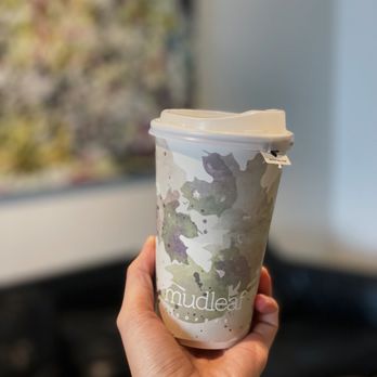 Mudleaf Coffee - a hand holding a cup of coffee - Coffee & Tea Near Me - Plano, Texas