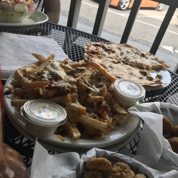 Tulips American Grub and Pub - Bacon cheese fries and skillet pizza in back. - Pubs Near Me - Johnson City, Tennessee Tulips American Grub and Pub - Bacon cheese fries and skillet pizza in back. - Pubs Near Me - Johnson City, Tennessee