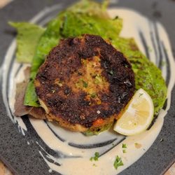 805 Coastal Kitchen - Crab cakes with a smoked paprika aioli, dressed greens and topped with a smoked finishing salt!