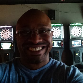 The Dawg House Pub - a smiling man in front of a row of slot machines - Pubs Near Me - Merrillville, Indiana