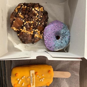 Voodoo Doughnut - Memphis Mafia, grape ape, and universal orange creamsicle. - Bakeries Near Me - Orlando, Florida