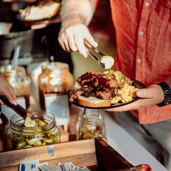 City Barbeque - a man holding a plate of food - Barbeque Near Me - Solon, Ohio
