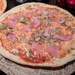 L‘Osteria - Pizza flopped over the edge of the plate by a wide margin. Ham, with mushrooms and artichokes. It was good.