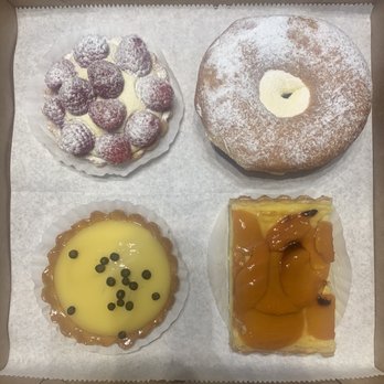 Flying With Jerome - Delicious assortment of pastries, to include a fresh fruit (raspberry) tart, a cream donut, apricot flan, and lemon tart - Breakfast & Brunch Near Me - Clearwater, Florida