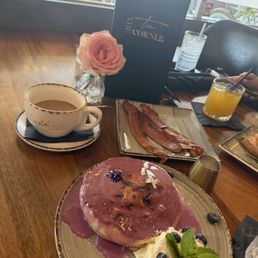 Coffee with vanilla cream lavender blueberry pancakes with whipped cream and 2 sides of bacon ( 2 slices for $6 was a little pricy ) Coffee with vanilla cream lavender blueberry pancakes with whipped cream and 2 sides of bacon ( 2 slices for $6 was a little pricy )