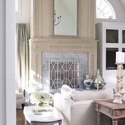 Postcard From Paris - An antique trumeau mirror is inset into the fireplace paneling. Carrara marble is used on the hearth. The firescreen is custom-d