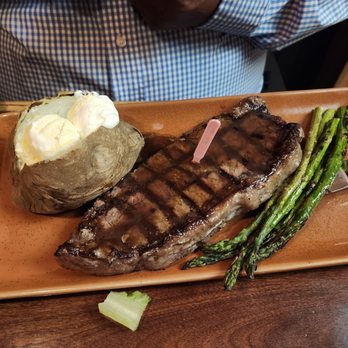 Tony Roma's - New York Steak with a baked potato and asparagus - Barbeque Near Me - Anaheim, California Tony Roma's - New York Steak with a baked potato and asparagus - Barbeque Near Me - Anaheim, California