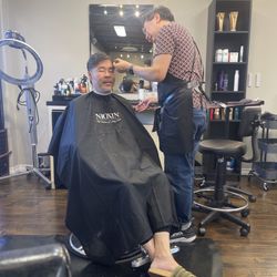 Cameo giving a client a haircut.