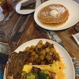 Crispy scrapple, pancakes , crispy bacon cream cheese cheddar cheese jalapeño omelette, rye bread, potatoes fresh brewed iced tea.