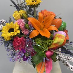 Sunflowers, orange lily's, hot pink carnations, mini green hydrangeas, pink spray roses, Easter accents