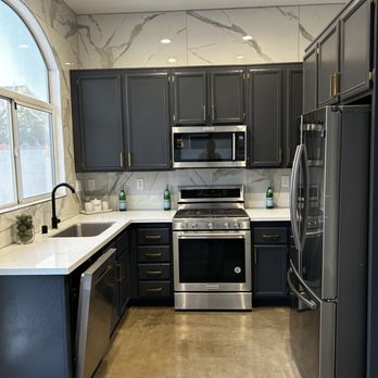 C&G Services - a kitchen with black cabinets and stainless steel appliances - Painters Near Me C&G Services - a kitchen with black cabinets and stainless steel appliances - Painters Near Me