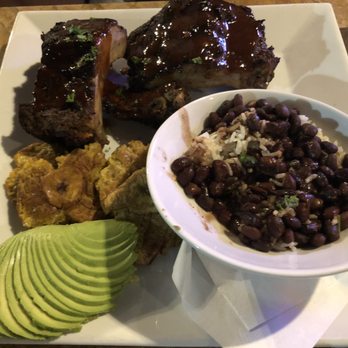 Hemingway's Tavern - Rib platter with tostones, rice, and beans (sliced avocado taken from another dish) - New American Near Me - Melbourne, Florida Hemingway's Tavern - Rib platter with tostones, rice, and beans (sliced avocado taken from another dish) - New American Near Me - Melbourne, Florida