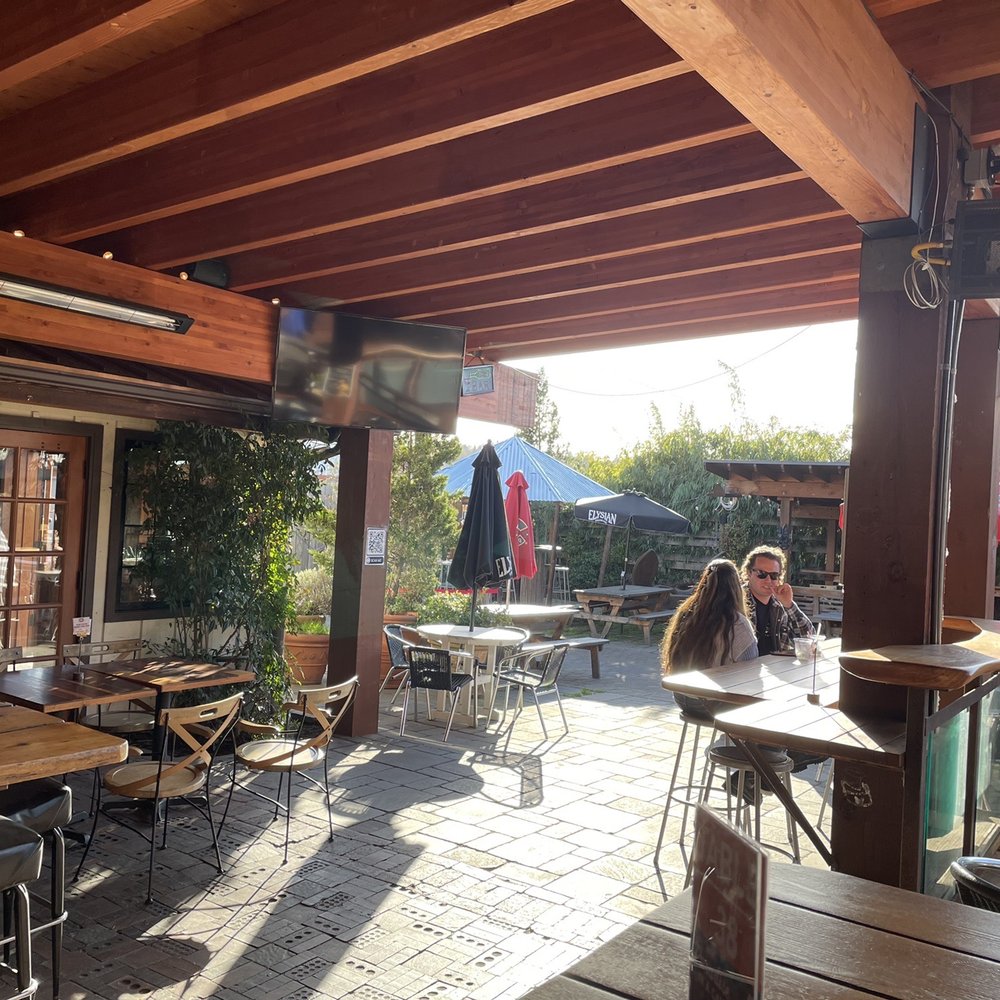 Pono Ranch - Covered patio, looking from NE corner south toward the interior bar - American Near Me - Seattle, Washington Pono Ranch - Covered patio, looking from NE corner south toward the interior bar - American Near Me - Seattle, Washington