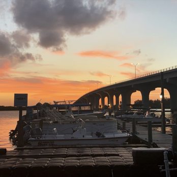 Riverside Cafe - a sunset view of a bridge and boats - Sports Bars Near Me - Vero Beach, Florida