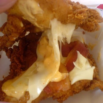 KFC - Inside shot of the gooey cheese and bacon between two chicken patties - Fast Food Near Me - Bellingham, Washington KFC - Inside shot of the gooey cheese and bacon between two chicken patties - Fast Food Near Me - Bellingham, Washington