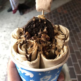 Blue Nova - a hand holding a cup of ice cream with an oreo cookie on top - Food Trucks Near Me - Los Angeles, California