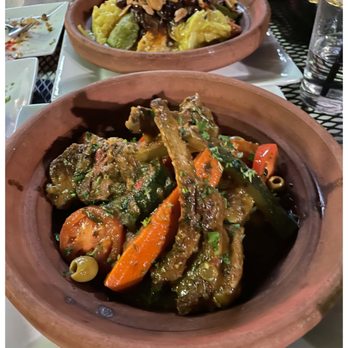 Andalusia - Lamb tagine (foreground) and vegetable couscous - Moroccan Near Me - Memphis, Tennessee Andalusia - Lamb tagine (foreground) and vegetable couscous - Moroccan Near Me - Memphis, Tennessee
