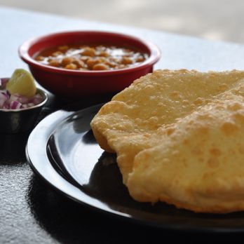 Curry On - Cholle with Bature - chick pea curry served with two fresh deep fried soft bread garnished with onion and lime - Indian Near Me - Ann Arbor, Michigan Curry On - Cholle with Bature - chick pea curry served with two fresh deep fried soft bread garnished with onion and lime - Indian Near Me - Ann Arbor, Michigan