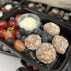 Macrobox Meals - Mango energy bites with dates, coconut, flax seeds, and lime zest. Served with a side of Greek yogurt and mixed fruit.