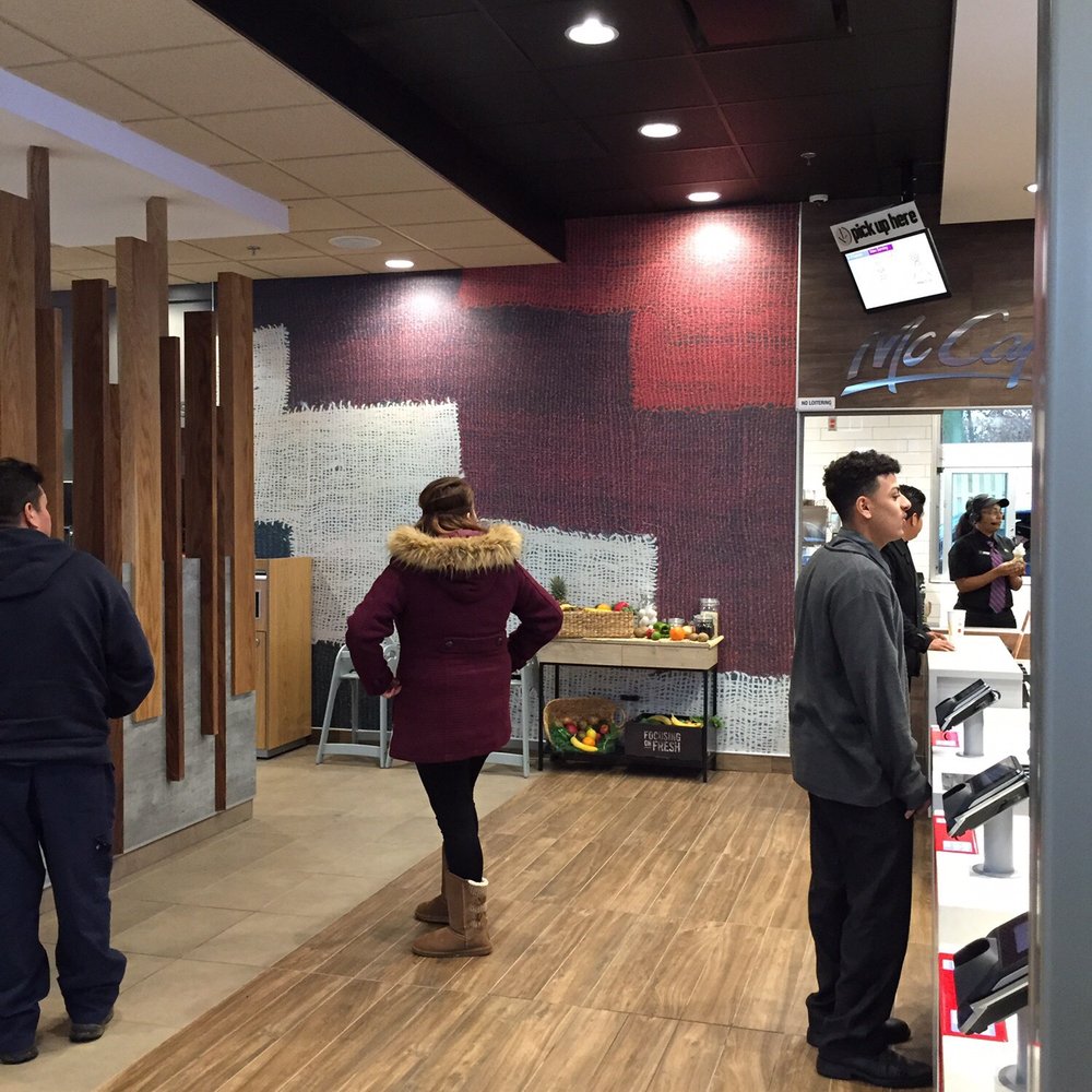 McDonald's - a woman walking through a store - Fast Food Near Me - Roselle Park, New Jersey