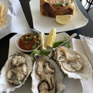 Photo of Nikka Fish Market and Grill - Goleta, CA, United States. Oysters in the front  Lobster roll in the back