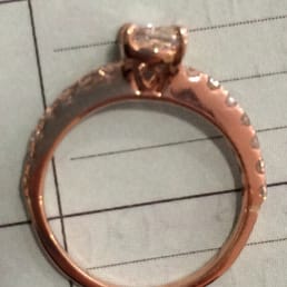The prongs are crooked.There are visible lines where band connects with the diamonds.