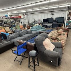 Bargain Thrift Store - Sofas, sectionals and TVs in the furniture area.