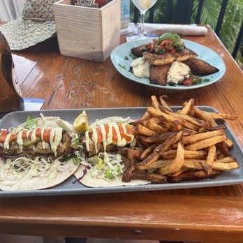 Hook'd USVI - Blackened mahi fish tacos, the background dish is the blackened mahi with cheesy grits and bacon and fried plaintains. - New American Near Me - Red Hook, Virgin Islands