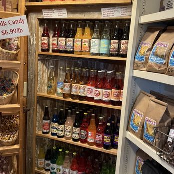 Old General Store - Wooden shelves hold assorted bottled sodas, craft beers, and canned drinks, with a sign advertising bulk candy nearby. - Grocery Near Me - Donegal, Pennsylvania
