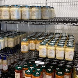a shelf of jars of sauces and condiments