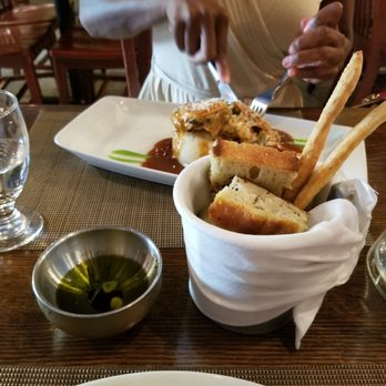 Sotto Sopra - Bread pieces for the table, and the Chicken Sotta Sopra behind it - Italian Near Me - Baltimore, Maryland