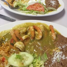 Shrimp with green sauce and enchilada with green sauce.