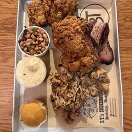Two meat platter + 2 piece fried chicken. Meat selections were smoked chicken and brisket. Sides were black eyed peas and sexy grits. Two meat platter + 2 piece fried chicken. Meat selections were smoked chicken and brisket. Sides were black eyed peas and sexy grits.