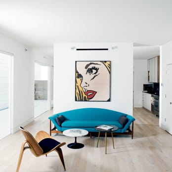 Interior Pros - Design Studio - a living room with a blue couch and a coffee table - Flooring Near Me - San Luis Obispo, California Interior Pros - Design Studio - a living room with a blue couch and a coffee table - Flooring Near Me - San Luis Obispo, California