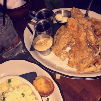 Moonshine Grill - Chicken and waffles with a side of grits. - Southern Near Me - Austin, Texas Moonshine Grill - Chicken and waffles with a side of grits. - Southern Near Me - Austin, Texas