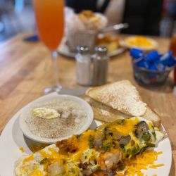 Yoolks On Us Southern Bistro - Fiesta chicken, omelette, grits, and toast