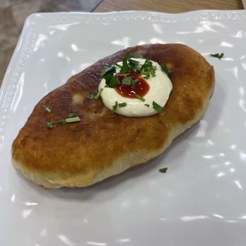 European Dumplings Cafe - Piroshki (baked Pierogi). Comes with 2 per order. We split the order to share along with the Borsh. - Ukrainian Near Me - Castle Hills, Texas European Dumplings Cafe - Piroshki (baked Pierogi). Comes with 2 per order. We split the order to share along with the Borsh. - Ukrainian Near Me - Castle Hills, Texas