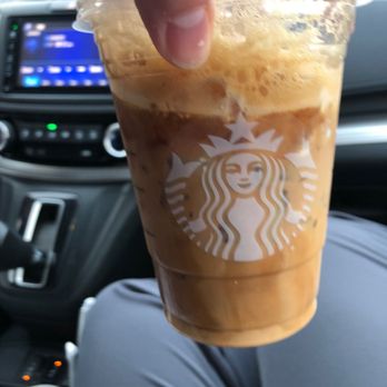 Starbucks - a hand holding a cup of iced coffee - Coffee & Tea Near Me - Baton Rouge, Louisiana Starbucks - a hand holding a cup of iced coffee - Coffee & Tea Near Me - Baton Rouge, Louisiana
