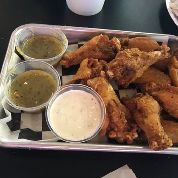 Revival Pizza - a tray of chicken wings with dipping sauces - Pizza Near Me - Monroe, Louisiana