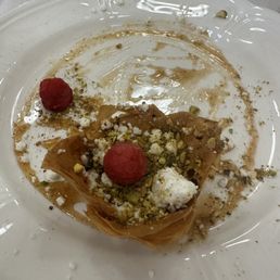 Goat cheese, pistachio, honey tart appetizer with raspberries