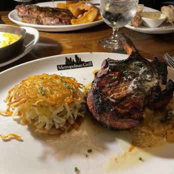 Metropolitan Grill - Pork chop and potatoes, steak and steak fries in the distance - American Near Me - Seattle, Washington
